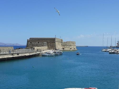 a group of boats in a body of water at Sea and Sun in Amoudara Herakliou