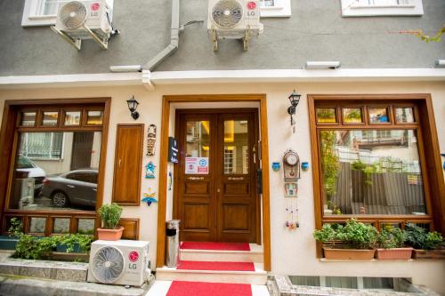 a front door of a house with potted plants at Constantinopolis Hotel in Istanbul