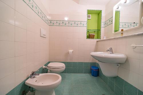 a bathroom with a toilet and a sink at Appartamenti Vista Mare - Goelba in Capoliveri