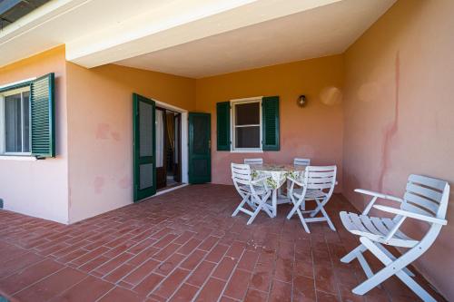 a patio with a table and chairs on a house at Appartamenti Vista Mare - Goelba in Capoliveri