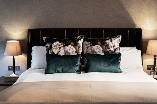 a bed with two pillows and two nightstands at Hotel du Vin & Bistro Cambridge in Cambridge