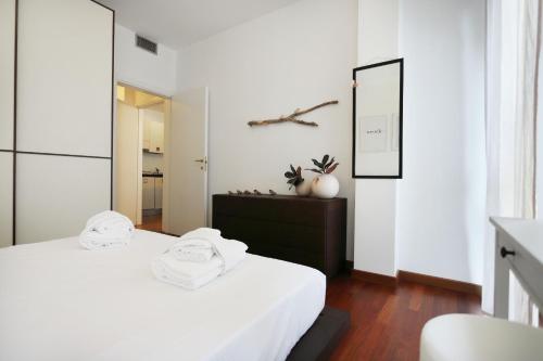 Yourbanflat Butterfly في بادوفا: غرفة نوم بيضاء مع سرير ومرآة