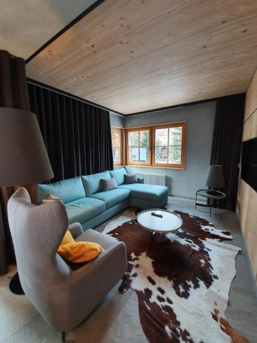 a living room with a couch and a table at Chalet Cirmolo in Livigno