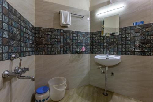 a bathroom with a sink and a toilet at KSTDC Hotel Mayura Nisarga Pearl Valley in Anekal