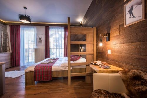 a bedroom with a bunk bed and a table at 4Roses Apartments in Smokovce