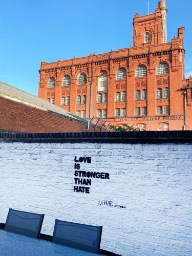 a mural on the side of a brick building at The Baltic Townhouses by Serviced Living Liverpool in Liverpool