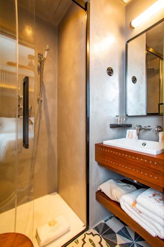a bathroom with a shower and a sink at Hotel La Torre del Canonigo - Small Luxury Hotels in Ibiza Town