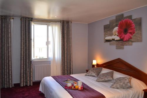 a bedroom with a bed with a tray of food on it at Marie Anne in Deauville