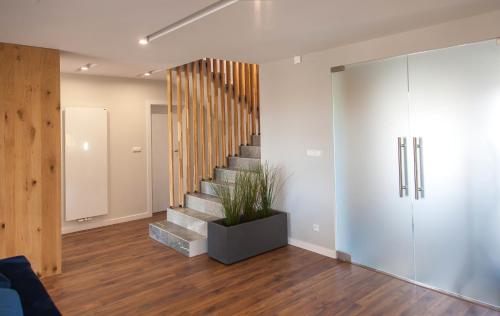 a staircase in a living room with a potted plant at Willa pod Lanckoroną in Izdebnik