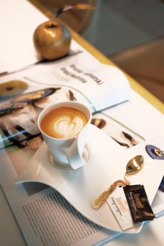 a cup of coffee on a plate on a table at Damianii Luxury Boutique Hotel & Spa in Omiš