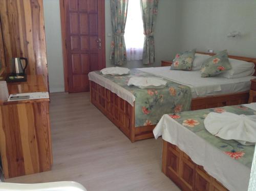 Una cama o camas en una habitación de Dalyan YUNUS HOTEL