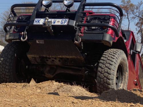 a red jeep parked in the dirt at Lanseria Country Estate in Lanseria