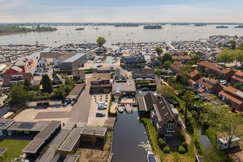 an aerial view of a town with a river at Hotel Café Restaurant Heineke in Loosdrecht