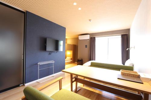 a small living room with a table and a couch at 5 minutes Shin-Osaka 9 in Osaka