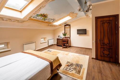 a bedroom with a large bed and a skylight at Mini-Hotel Guest House Inn Lviv in Lviv