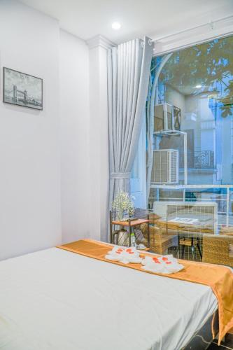 a room with a bed and a table and a window at Thức at 3am - Old Quarter Hanoi Lotus in Hanoi