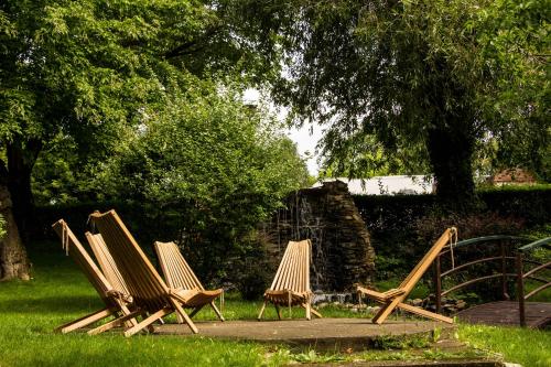 a group of lawn chairs sitting in the grass at Caro Hotel in Bucharest