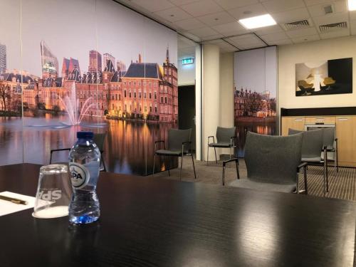 a bottle of water sitting on a table in an office at Mercure Hotel Den Haag Central in The Hague