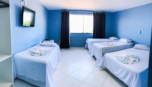 Säng eller sängar i ett rum på Hotel Luar de Itapua