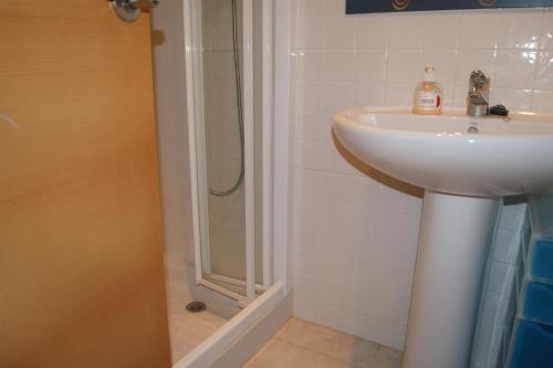 a bathroom with a sink and a shower at Residencial Sierra de Irta in Alcossebre