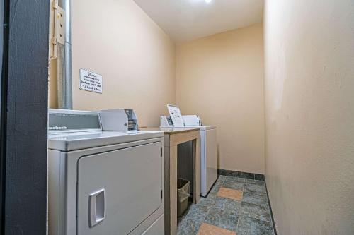 a laundry room with a washer and dryer at HFX Airport Hotel in Enfield