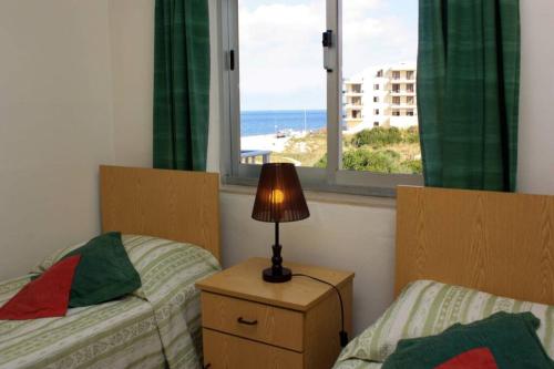 A bed or beds in a room at Fiesta Apartment Seaview