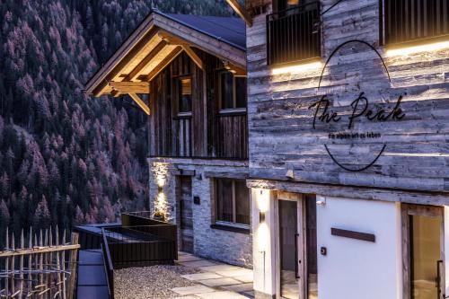 a building with a sign on the side of it at Chalets - The Peak in Sölden