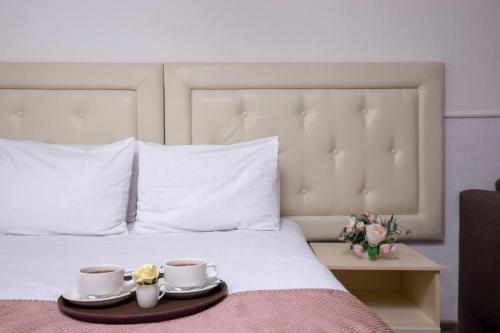 Кровать или кровати в номере Три Мушкетера Отель