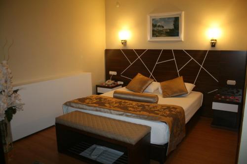a bedroom with a large bed with a large headboard at Nysa Hotel in Sultanhisar