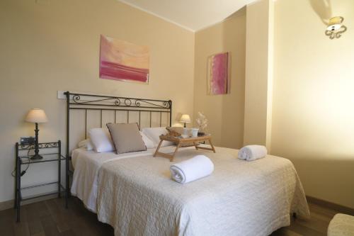 a bedroom with two beds with towels on them at Relais Bella Rosina Pool & Spa in Fiano