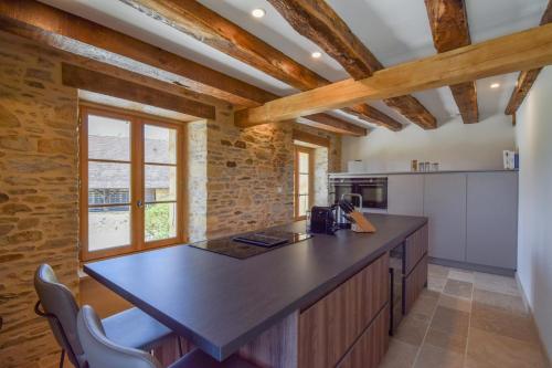 a kitchen with a large island with a counter top at Domaine d'Essendiéras in Saint-Médard-dʼExcideuil