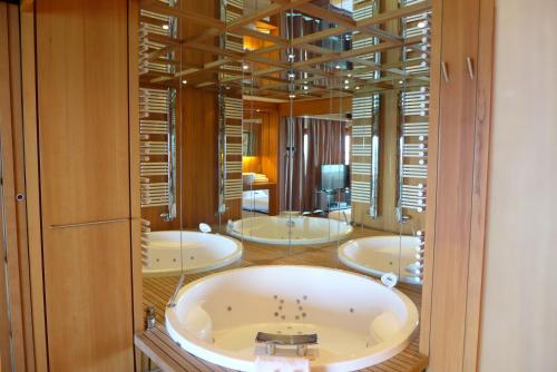 a bathroom with four sinks and a large mirror at Rabelais in Cannes