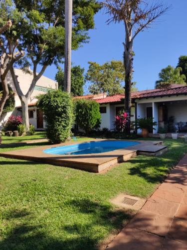 a house with a swimming pool in the yard at Apartamentos Don Gerardo in Asunción