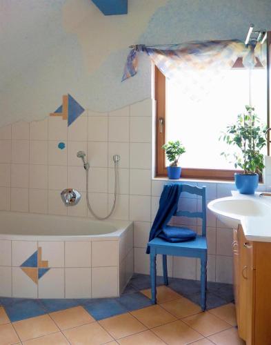 a bathroom with a tub and a sink at Haus "Andrea" in Hilders