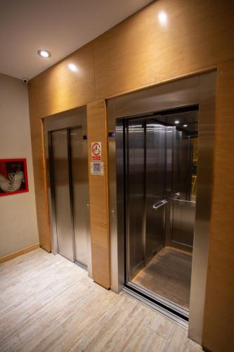 a hallway with two elevators in a building at Hotel EcoSki by bund in San Carlos de Bariloche