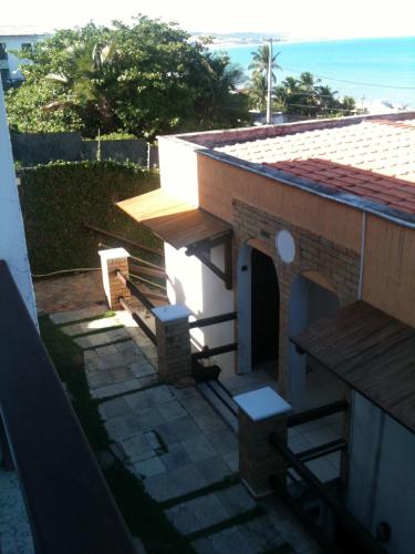 a view of a house with a porch and a patio at PontaNegra Ponta do Sol 5D Luciene Vista deslumbrante para o mar in Natal