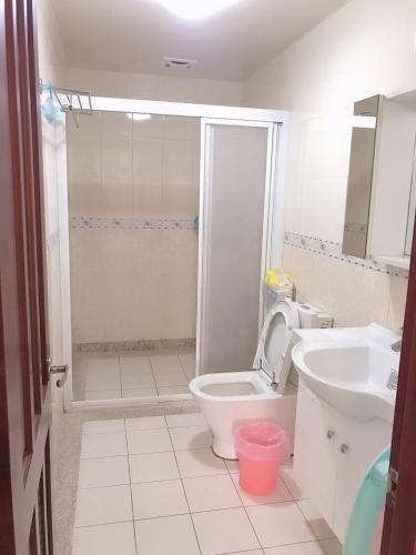 a bathroom with a shower and a toilet and a sink at Funny Eggs Guest House in Tainan