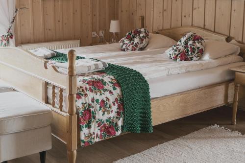 a bedroom with two beds with a green blanket on them at Zwijaczówka in Zakopane