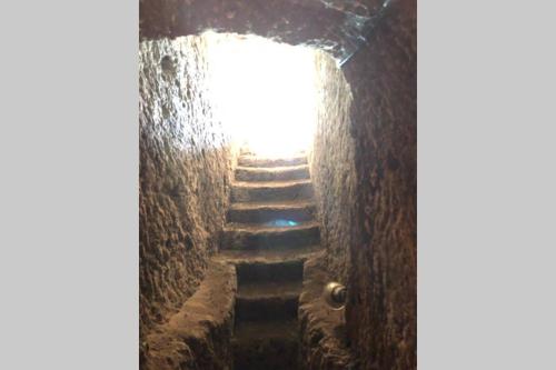 a stairway with a light at the top of it at Torre medievale Il Castellaccio in Civita Castellana