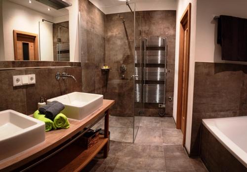 a bathroom with two sinks and a shower at Das Luegstein in Kiefersfelden