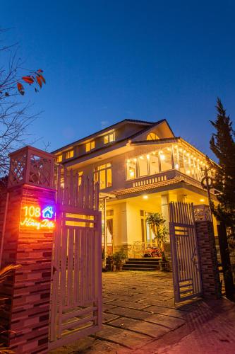 a house with a gate in front of it at Caly homestay in Da Lat