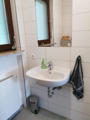 a bathroom with a white sink and a mirror at Ferienhaus Nele in Hilders