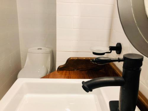 a bathroom with a sink and a toilet at Hotel Boutique Casa de las Manrique in Guanajuato
