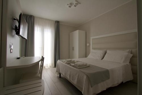 a bedroom with a bed and a tub and a sink at La Guitgia Rooms in Lampedusa