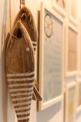 a pair of shoes hanging on a wall with a clock at CARNEIROS BEACH RESORT AP 311 E in Praia dos Carneiros