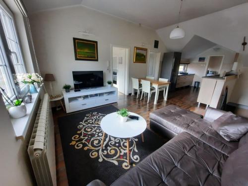 a living room with a couch and a table at Dream apartments in Novi Sad