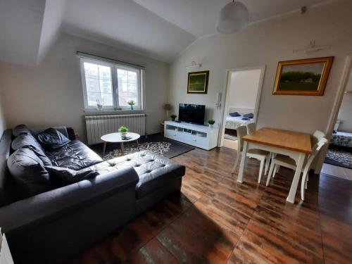 a living room with a couch and a table at Dream apartments in Novi Sad