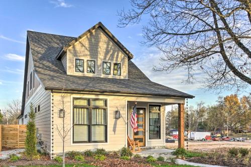 a house with a flag in front of it at Airy Bentonville Studio Less Than 1 Mile to City Square! in Bentonville