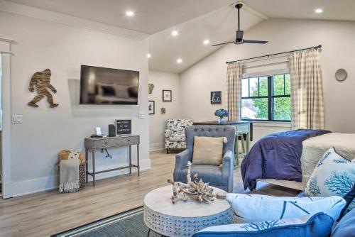 a living room with a blue couch and a table at Airy Bentonville Studio Less Than 1 Mile to City Square! in Bentonville