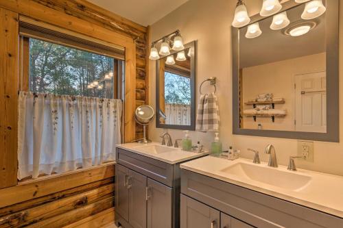 a bathroom with a sink and a large mirror at Finns Cabin - Blue Ridge Mountain Retreat! in Travelers Rest